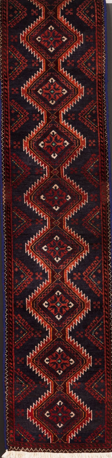 A Baluchi rug, IranWool and cotton of geometric and floral pattern in beige, bordeaux and blue s