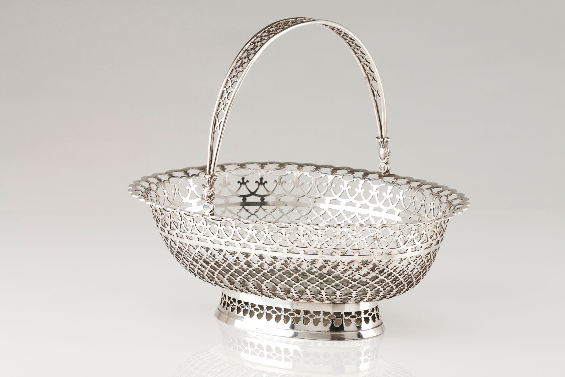 A bread basketPortuguese silver, 19th century Plain centre, geometric motifs pierced oval shaped