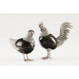 A cockerel and henSilver and hardstone Moulded, engraved and chiselled silver with applied glass