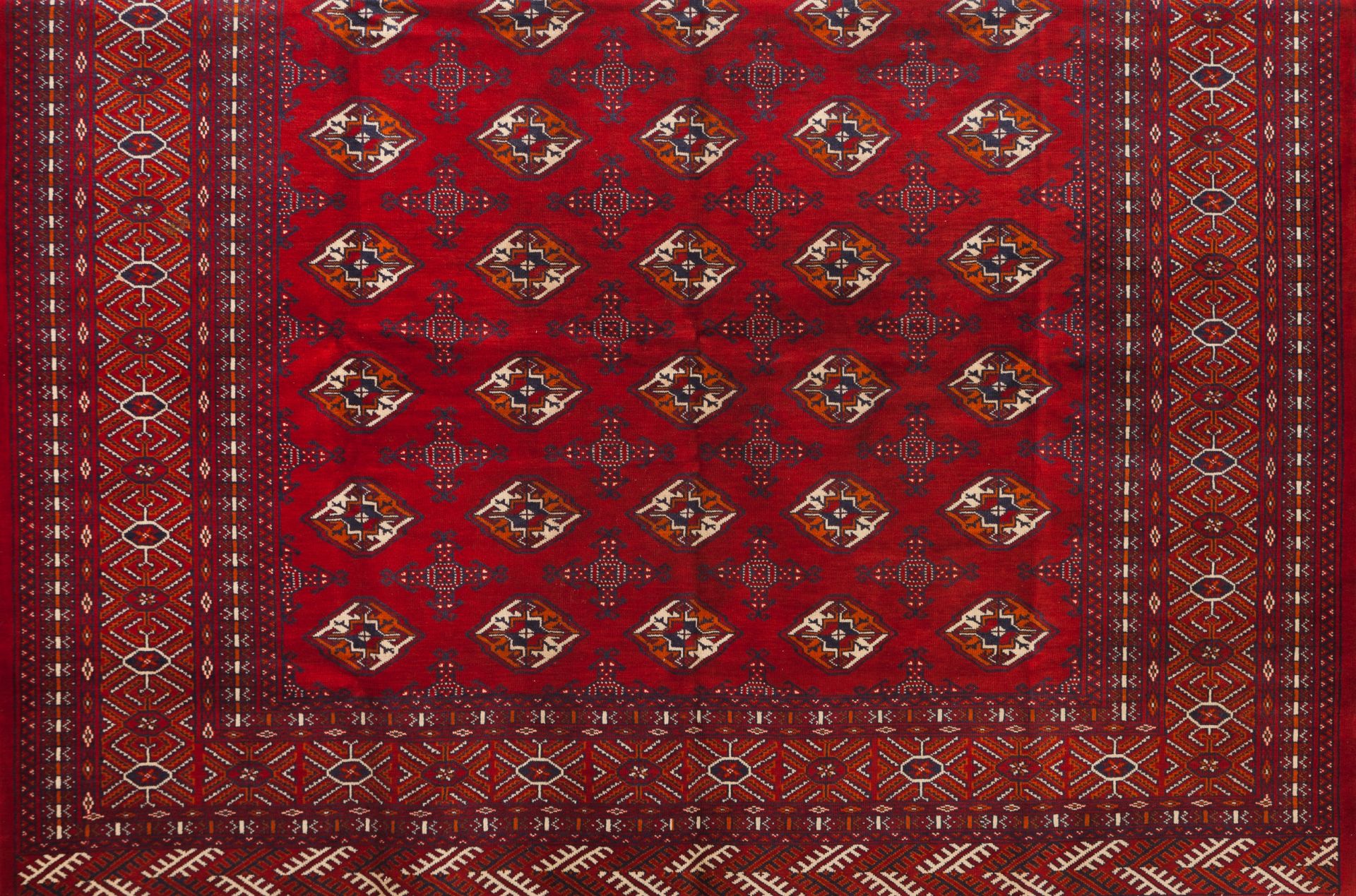 A Bukhara rug, IranWool and cotton of geometric pattern in bordeaux and beige340x265 cm