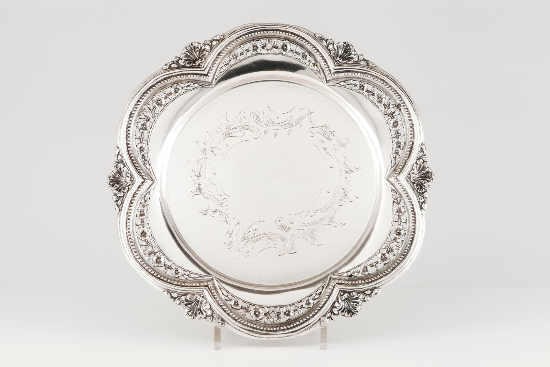 A salverPortuguese silver Floral and foliage chiselled centre of scalloped and pierced decoratio