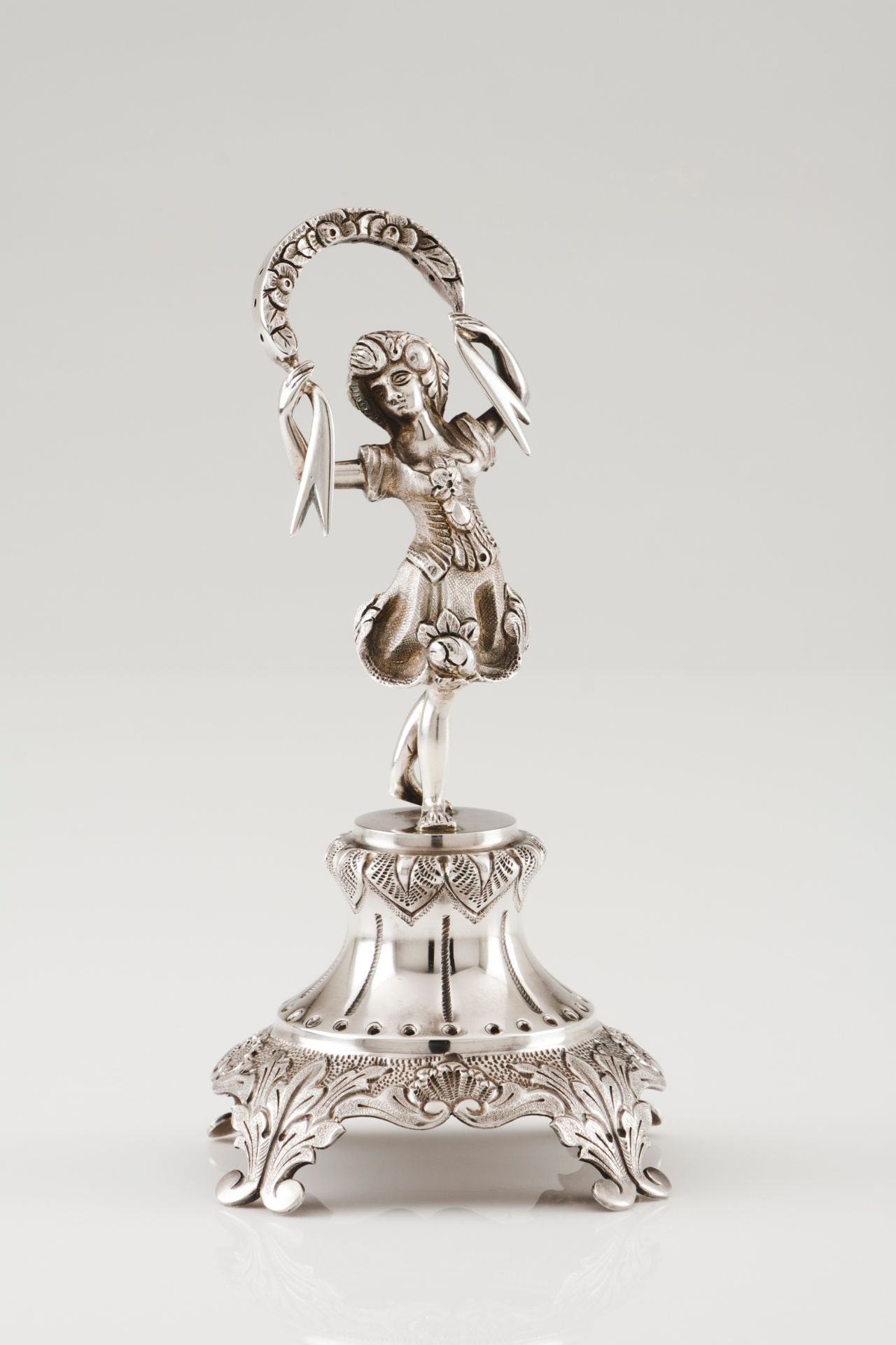 A toothpick holderPortuguese silver Ribbon holding girl figure on a plinth with foliage engraved