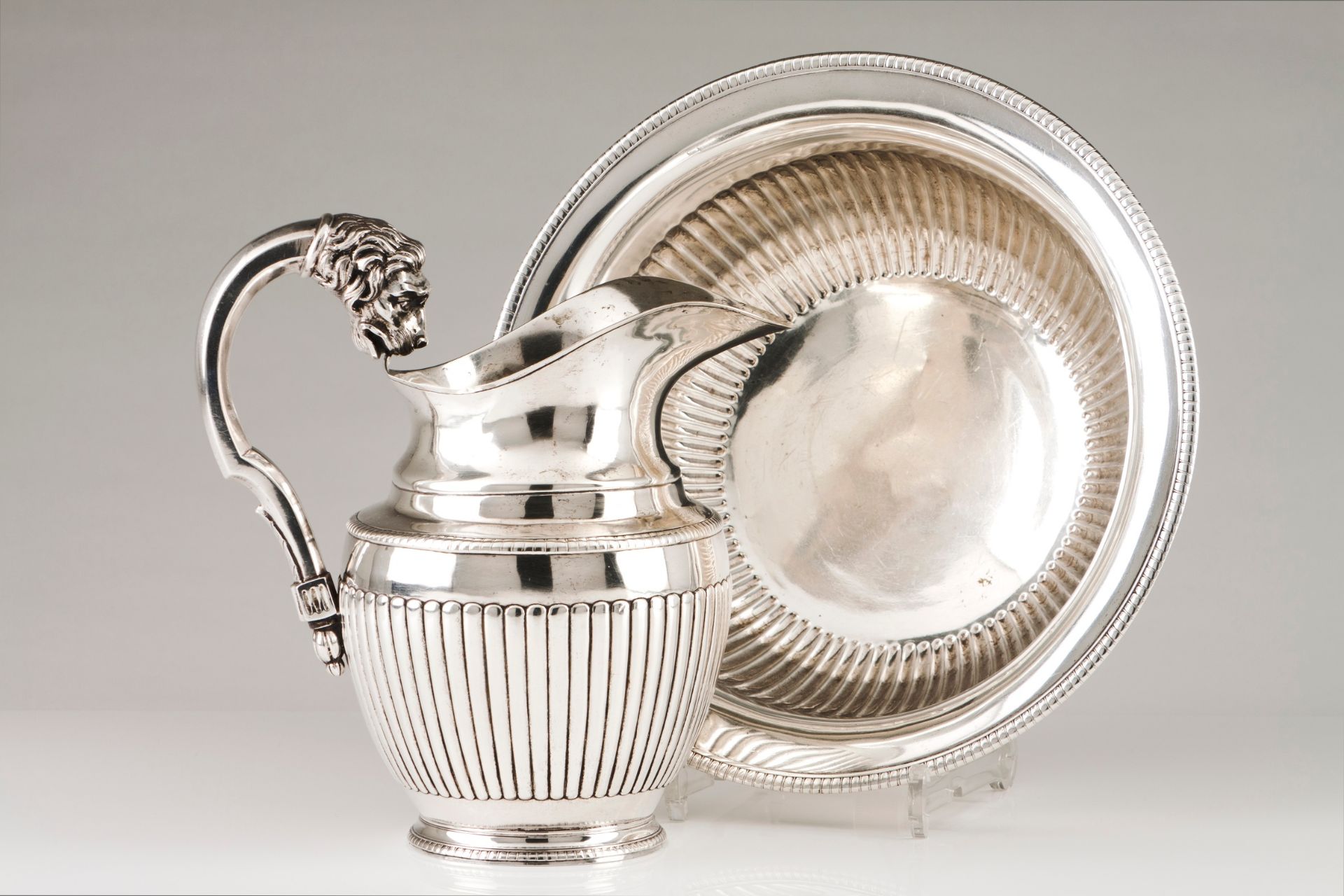 A ewer and basinPortuguese silver, 19th century Part fluted body of gadrooned lip Faceted handle