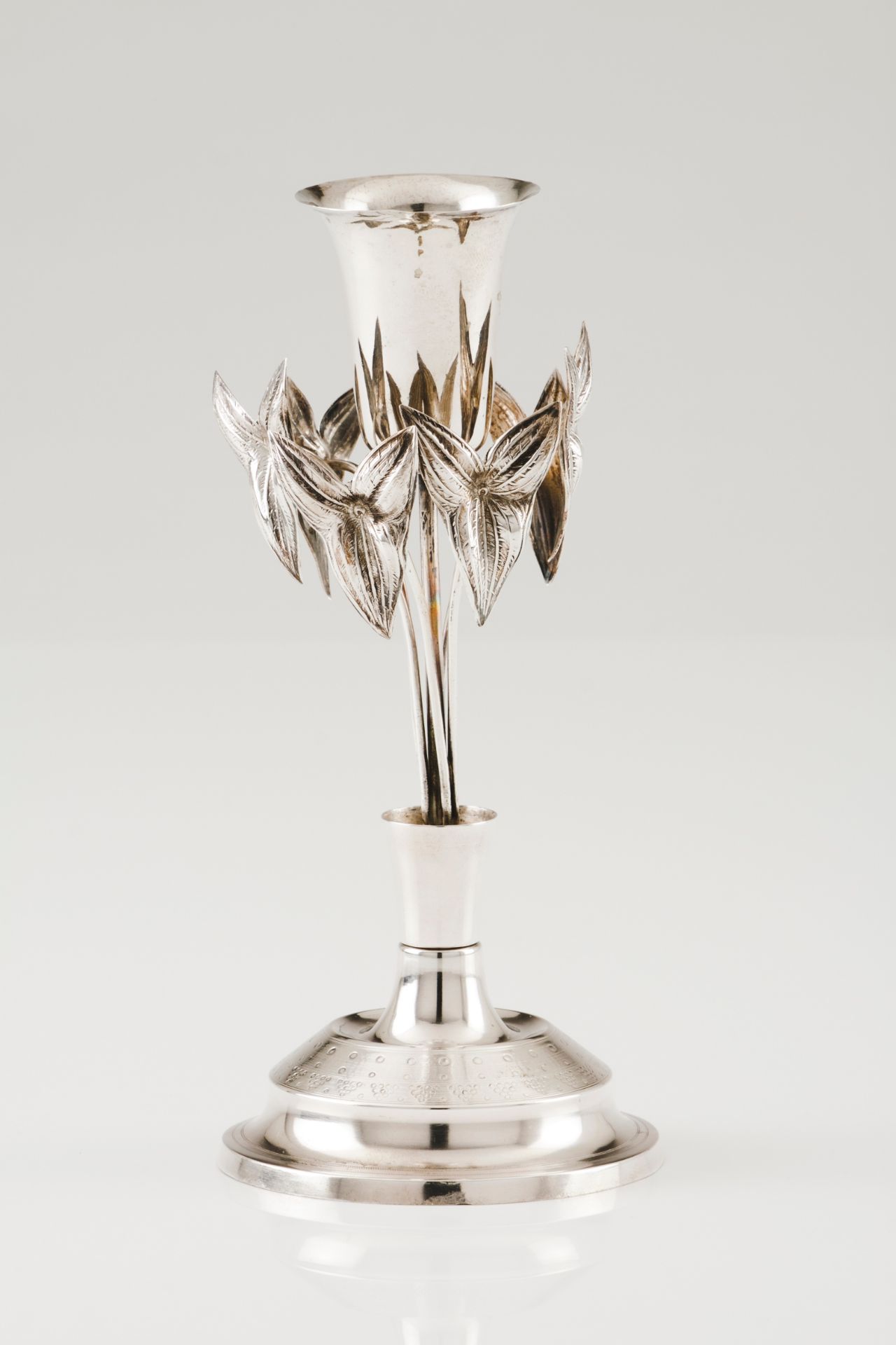 A toothpick holderPortuguese silver, 19th century Foliage and flower on a circular raised stand