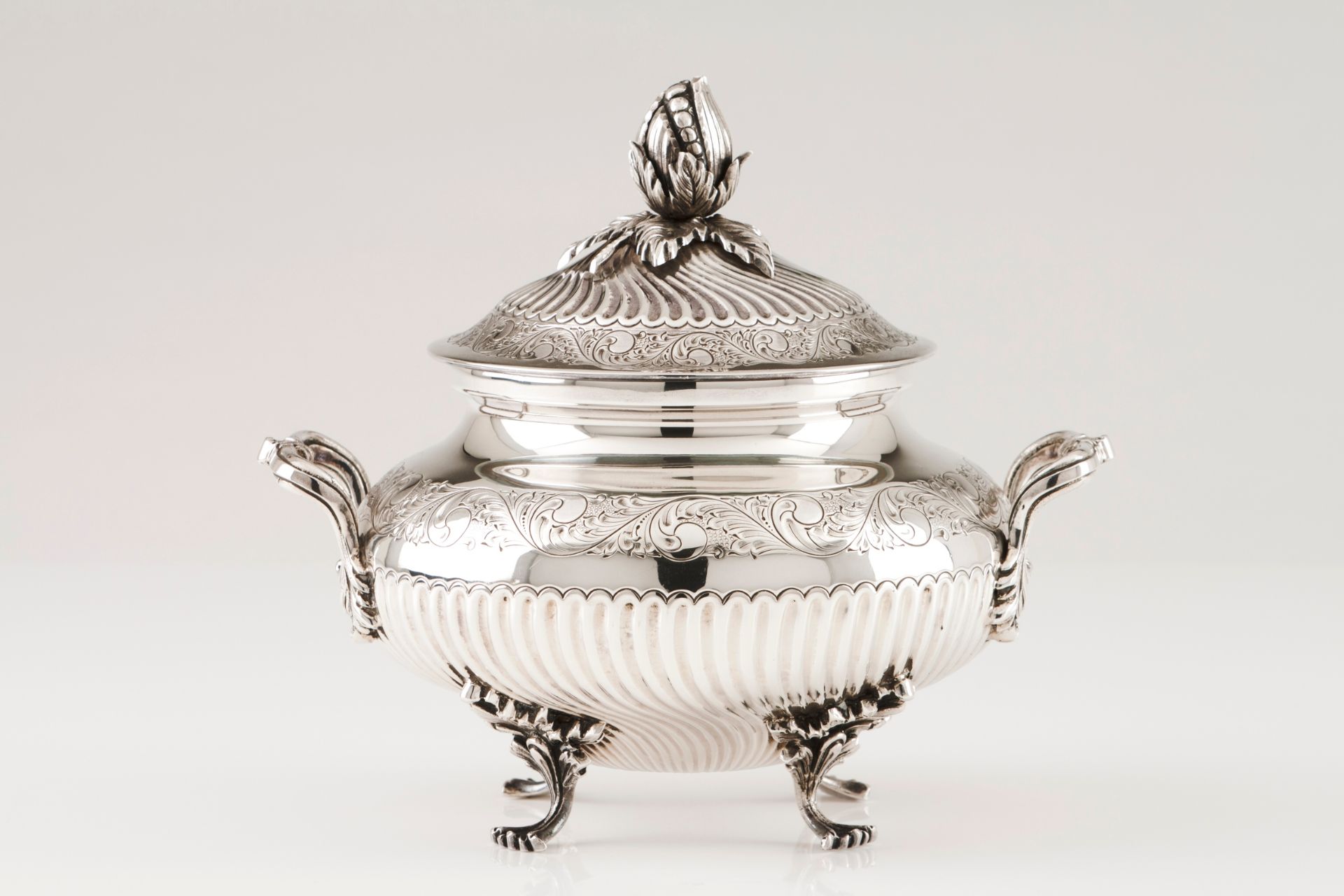 A tureen with coverPortuguese silver Circular body of spiralled fluting and floral bands decorat