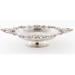 A footed fruit bowlPortuguese silver Elliptic shaped body of protruding handles Plain centre