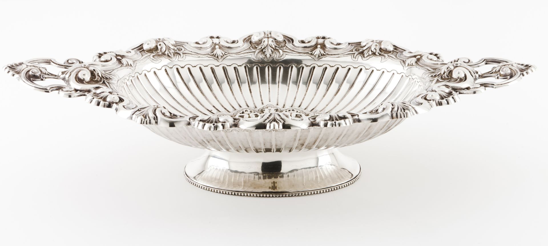 A footed fruit bowlPortuguese silver Elliptic shaped body of protruding handles Plain centre