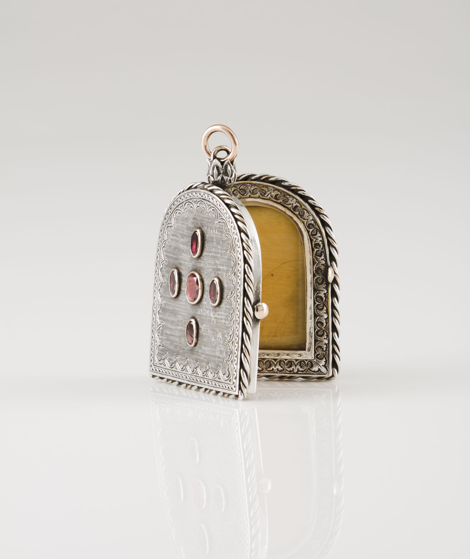 A reliquary and picture holderSilver with gold suspension rings Shaped as a Roman arch framed by