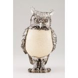 An owlSilver and ostrich egg Low relief, engraved and chiselled silver with applied garnet eyes