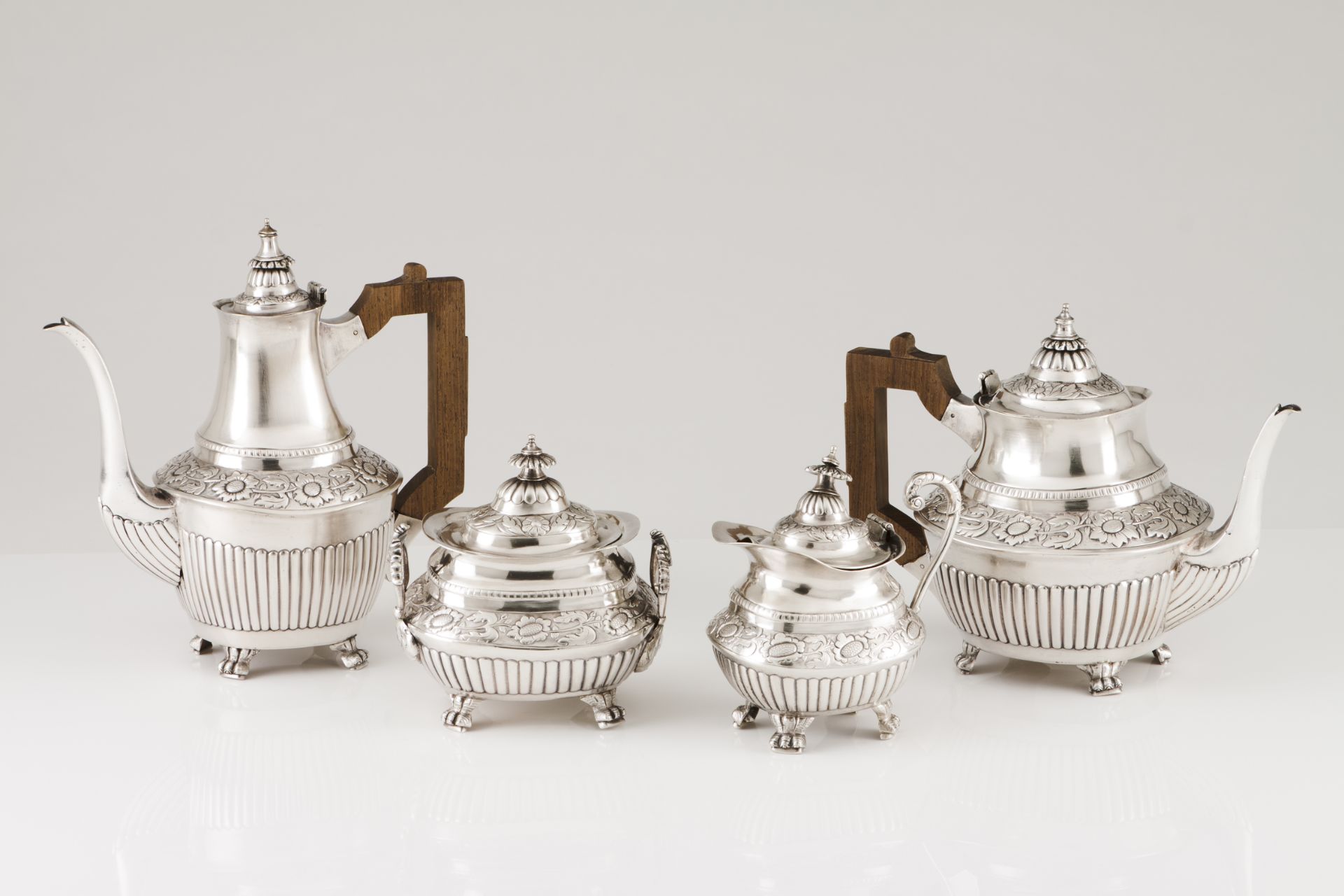 A tea and coffee setPortuguese silver, 19th century Part fluted body of raised floral and