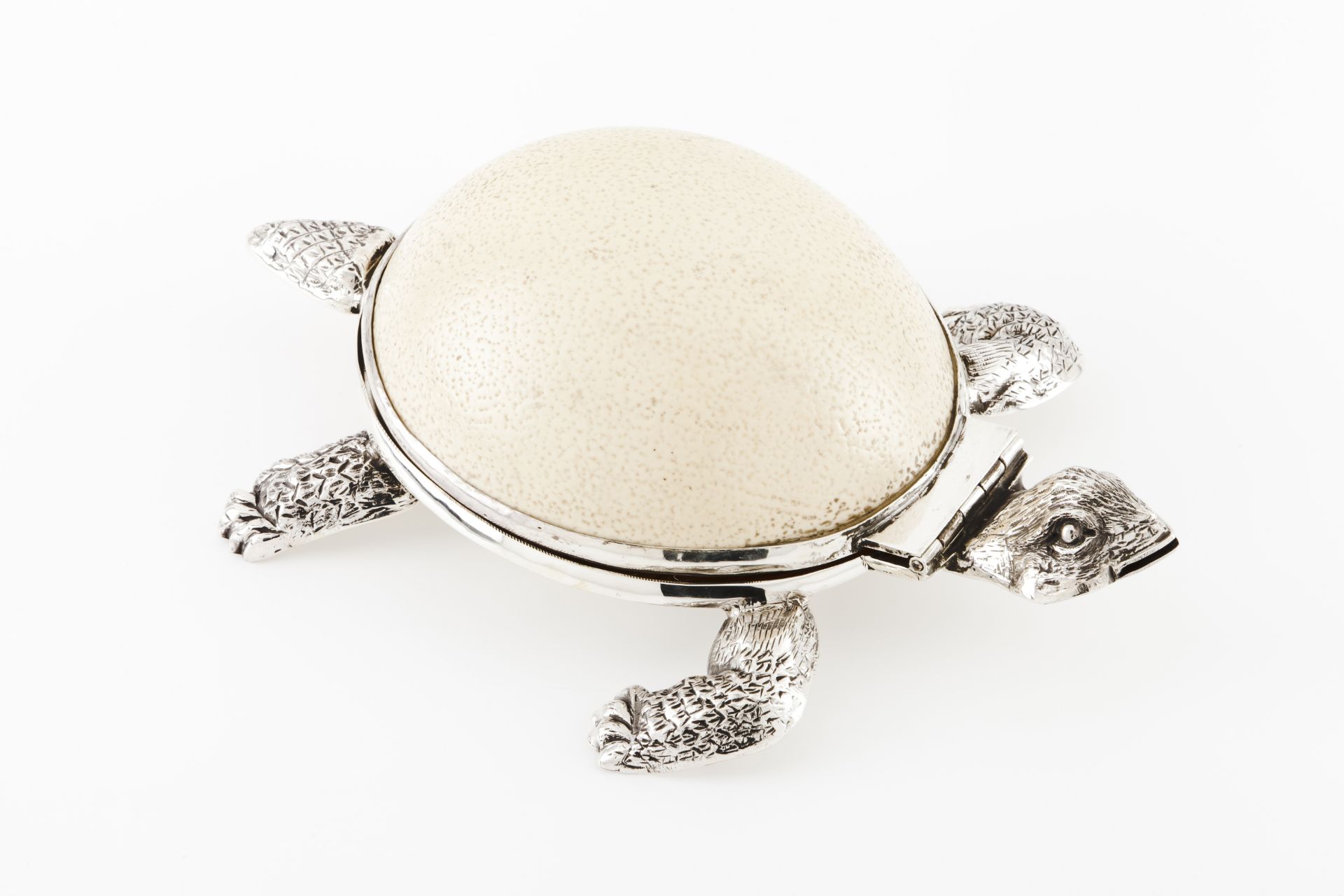 A tortoise boxSilver and ostrich egg Moulded and engraved box with hinged ostrich egg cover Eagle