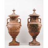 A pair of large amphoraeCeramic Low-relief decoration of grapes, foliage and classical motifs