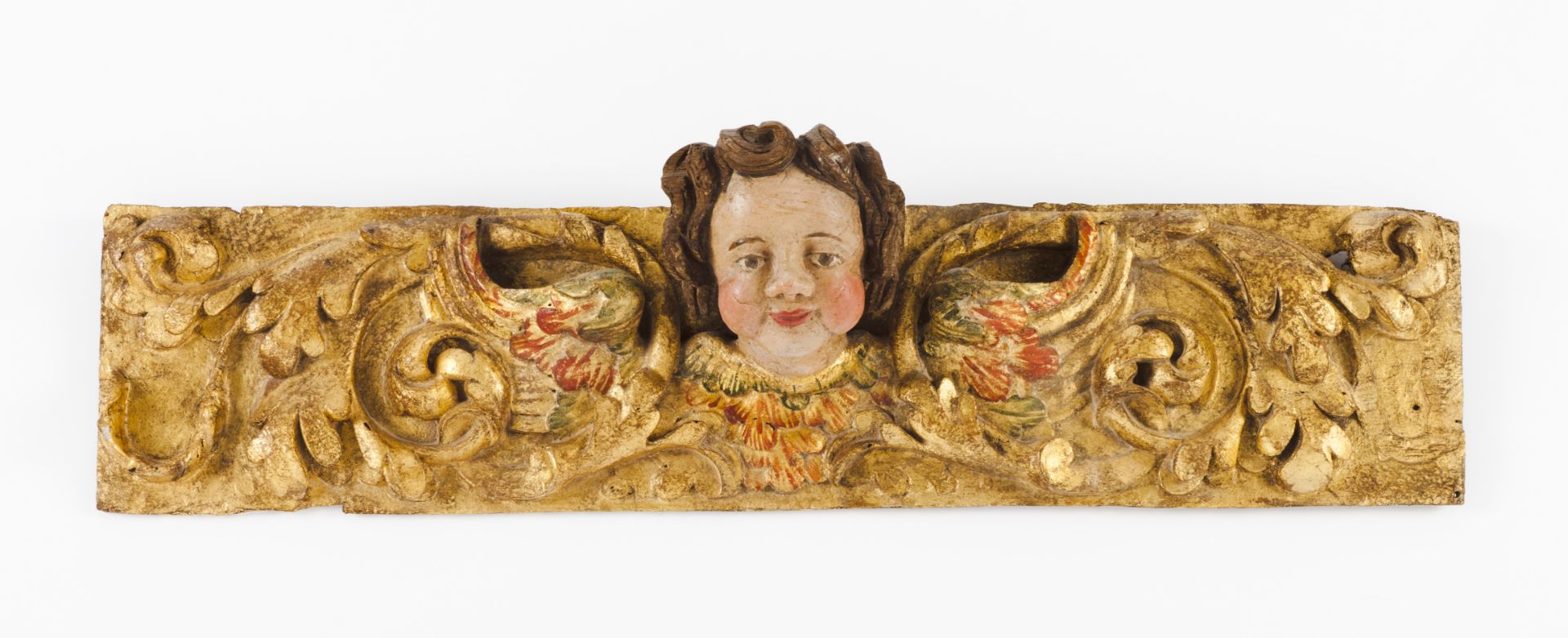 Two carved fragmentsCarved, gilt and polychrome wood Angel's heads and foliage scroll decoration