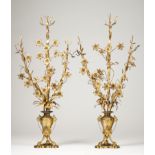 A pair of bouquetsGilt metal Stems decorated with flowers and leaves Amphora shaped bases