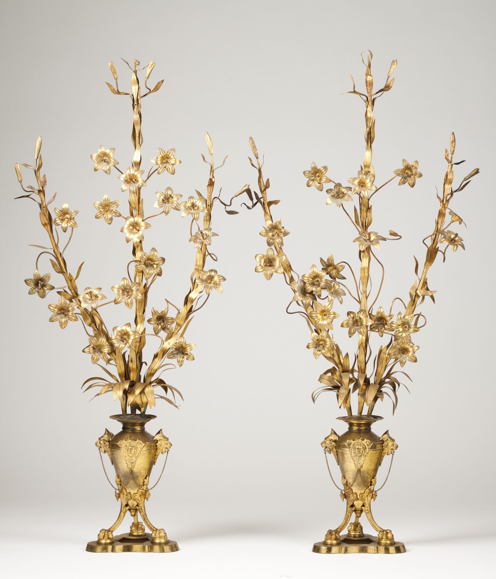 A pair of bouquetsGilt metal Stems decorated with flowers and leaves Amphora shaped bases