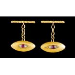 A pair of cufflinksPortuguese gold Hammered elliptic shaped set with ruby and crowned rose cut