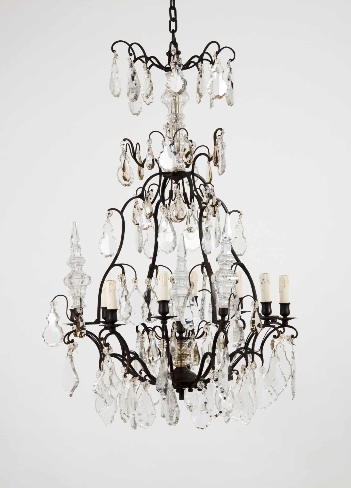 An eight branch chandelierPatinated metal With cut and molded crystal drops Late 19th century, early