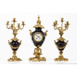 A Louis XV style garnitureA pair of five branch candelabra and clock with enamelled dial and Roman