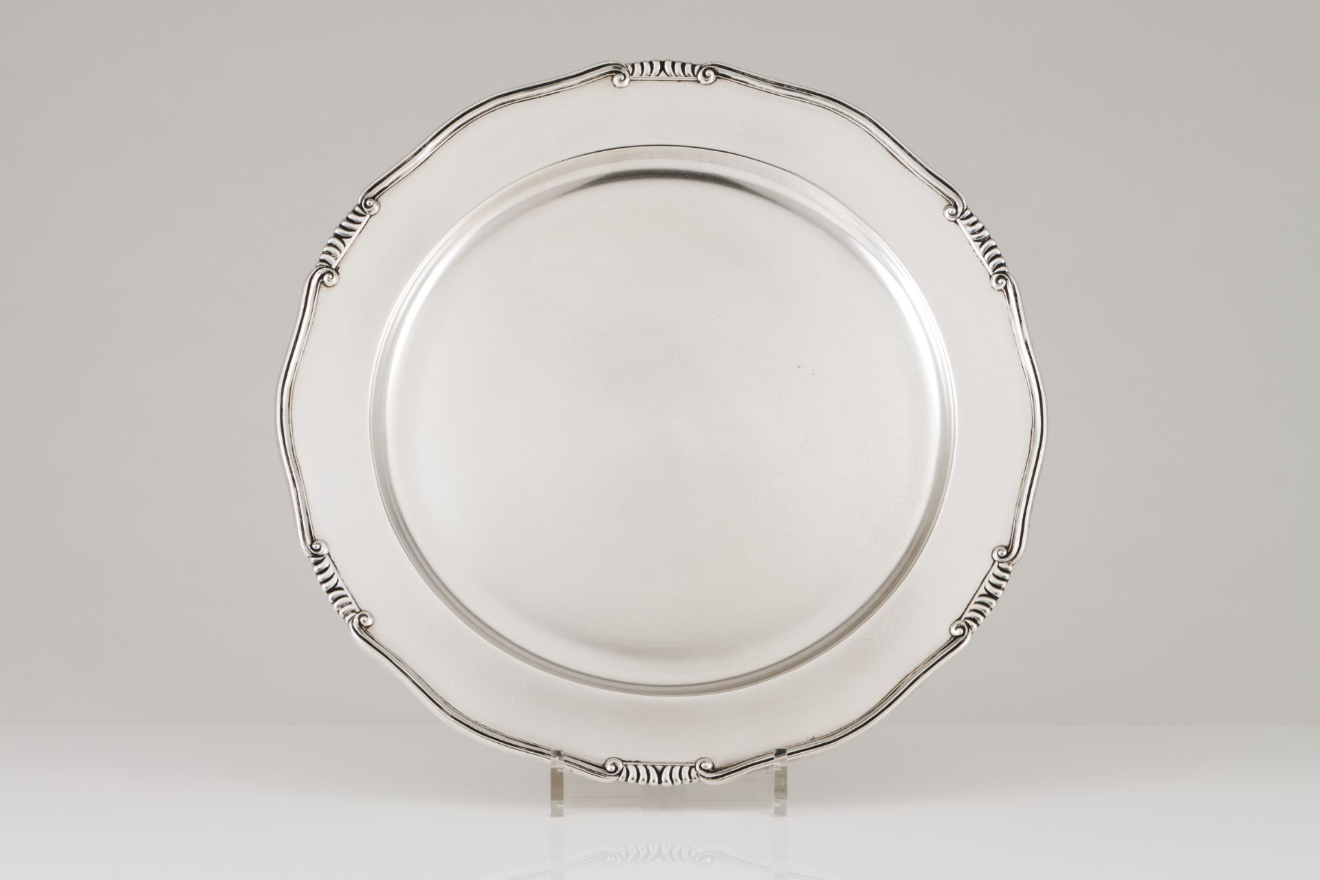 A large serving platterPortuguese silver Plain centre and scalloped lip of volutes and gadrooned