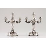 A pair of four branch candelabraPortuguese silver Profuse winglets, palms and acanthus raised