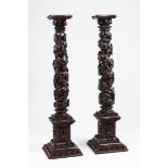 A pair of columnsCarved wood Square stand of raised foliage decoration Shaft of raised vines and