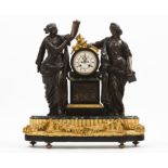 A large table clockBronze and marble Enamelled dial of Roman numbering, flanked by two figures