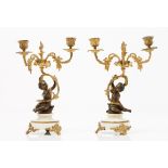 A pair of Napoleon III three branch candelabraGilt bronze of putti shaped shaft Marble stands