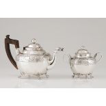 A teapot and sugar bowlPortuguese silver, 19th century Body and cover of raised foliage band