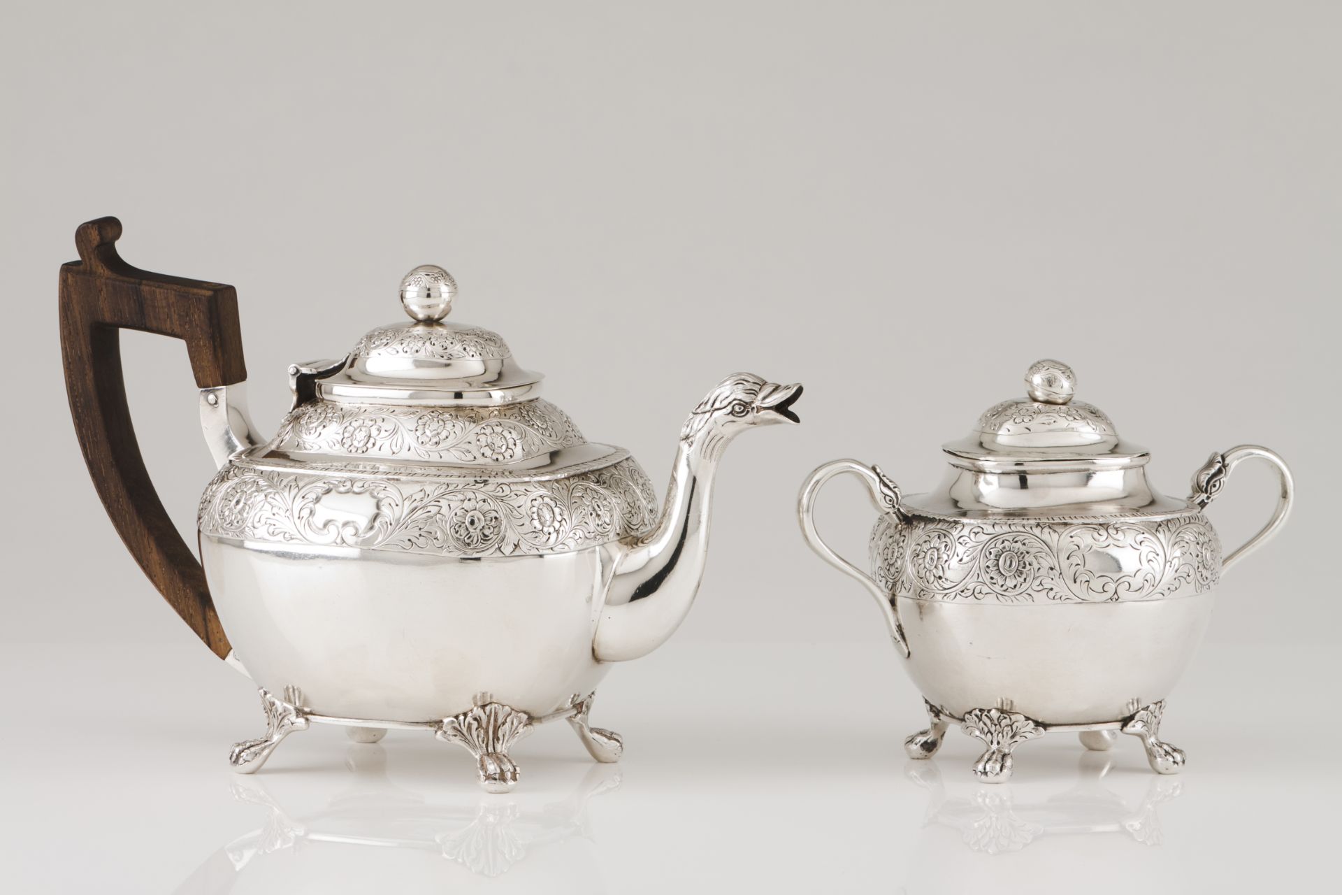 A teapot and sugar bowlPortuguese silver, 19th century Body and cover of raised foliage band