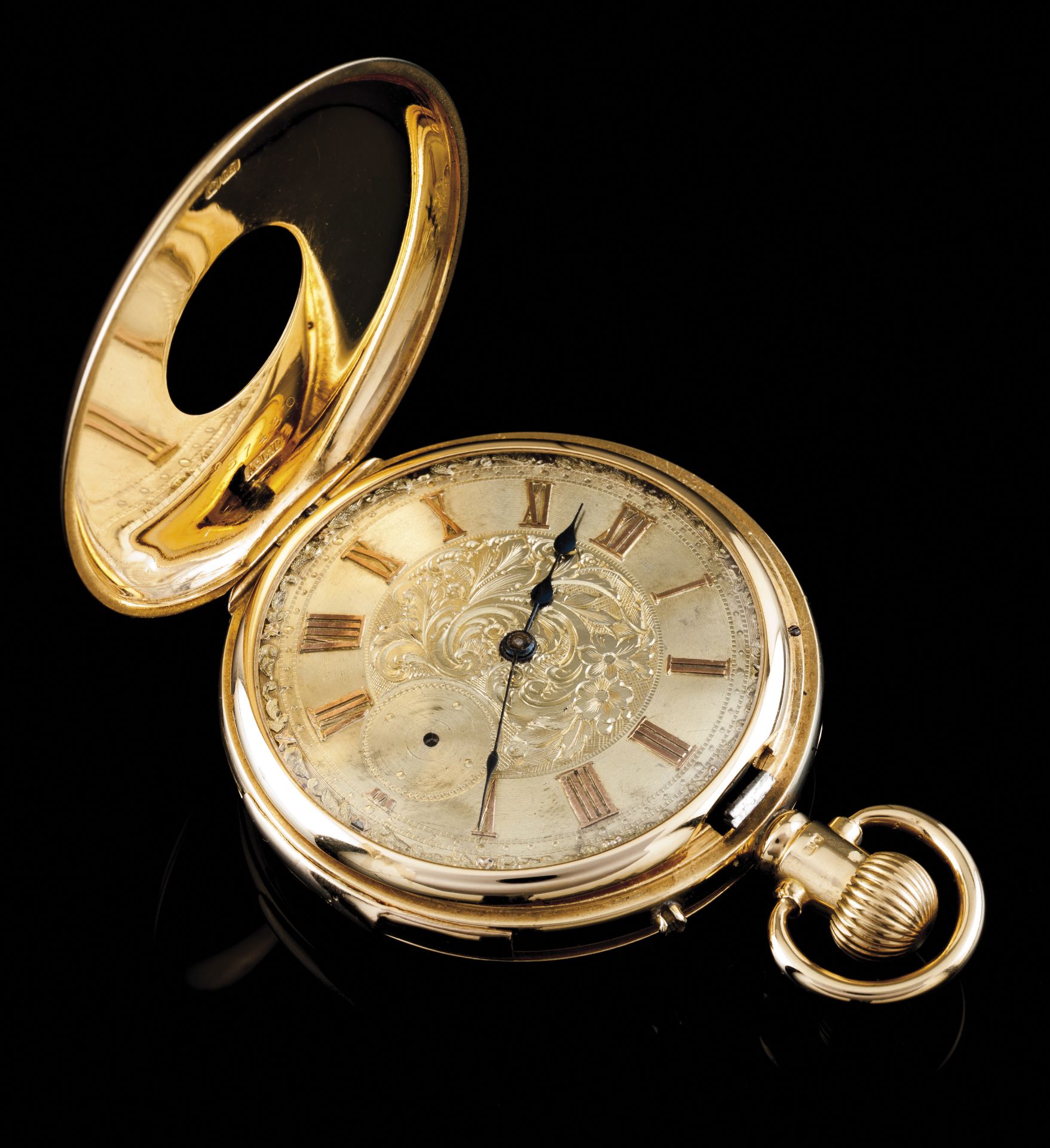 A half-hunter pocket watchGold case 750/1000 Gilt and chiselled dial of foliage inspired motifs,