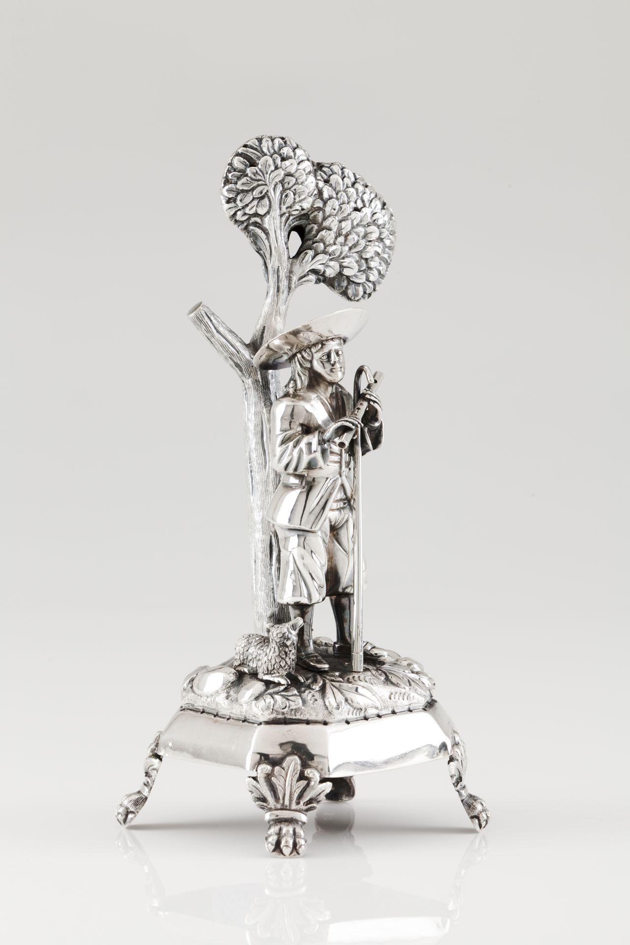 A toothpick holderPortuguese silver, 19th century A flute playing shepherd and a ram on a zoomorphic