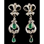 A pair of drop earringsSilver and Portuguese gold A bow with drop set with oval cut emerald (ca. 6x4