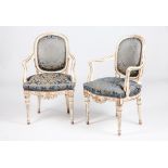 A pair of fauteuilsLacquered and silvered timber Carved foliage motifs decoration and silk