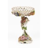 A footed fruit bowlPolychrome porcelain Pierced basket of floral high relief decoration and angel