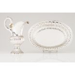 A basin and ewerPortuguese silver Part gadrooned body, scalloped rim, volute handle of chiselled