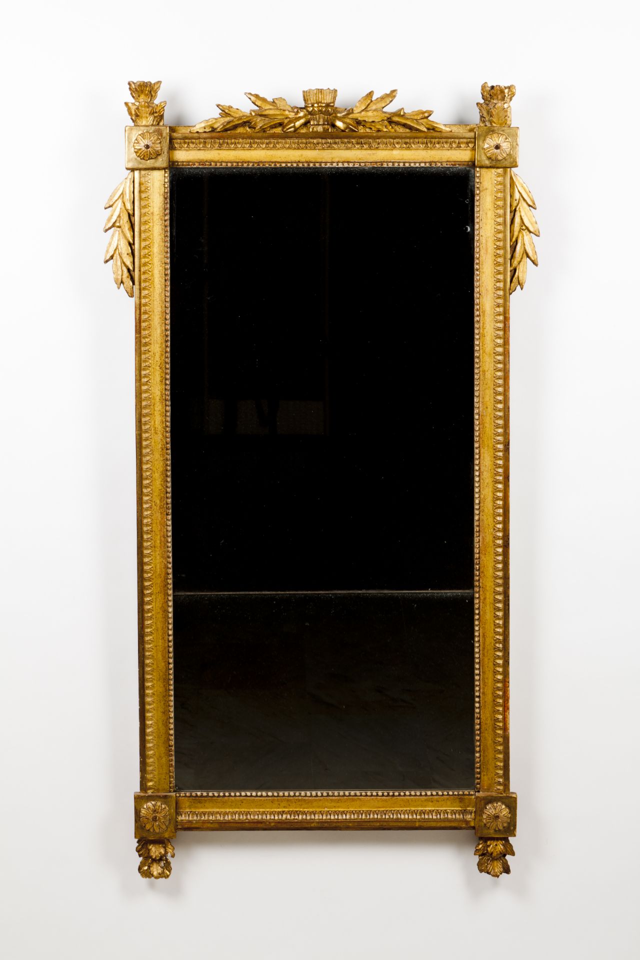 A louis XVI wall mirrorCarved and gilt wooden frame Beading, rosettes and foliage decoration