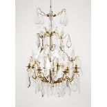 A nine branch chandelierPatinated metal With cut and molded crystal drops Late 19th century, early