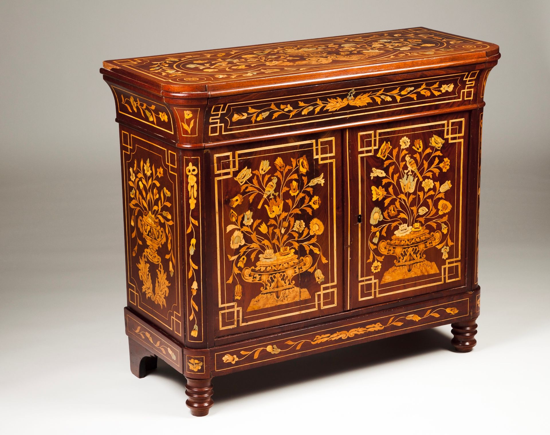 A small Dutch cabinetMahogany with marquetry decoration Depicting vases with flowers One drawer