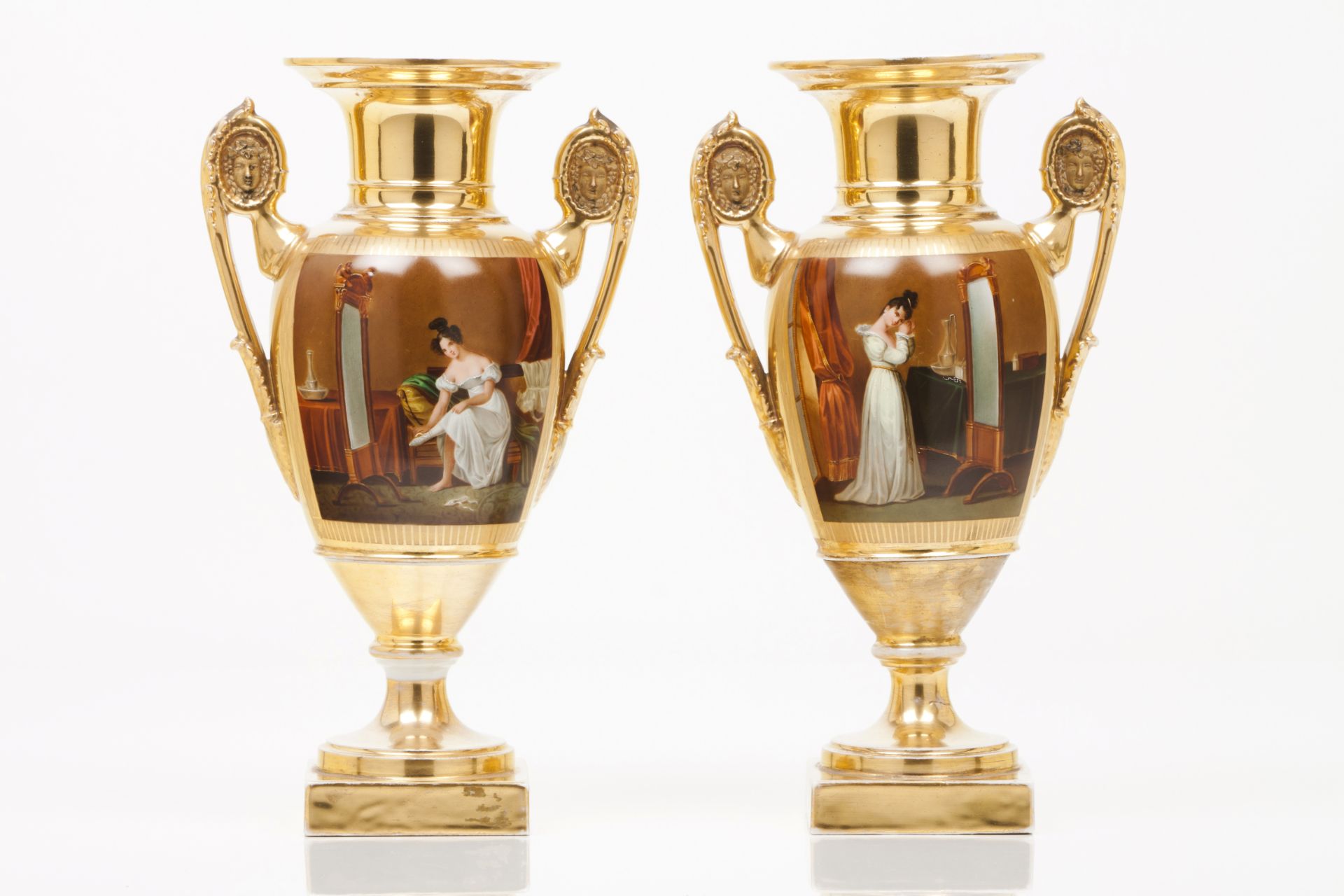 A pair of Empire vasesFrench porcelain Gilt and painted decoration depicting domestic scenes with
