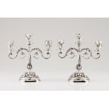 A pair of three branch candelabraPortuguese silver Profuse decoration of raised acanthus leaves