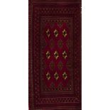 A Turkmen rug, IranWool and cotton Geometric pattern in bordeaux, beige and blue shades108x51 cm