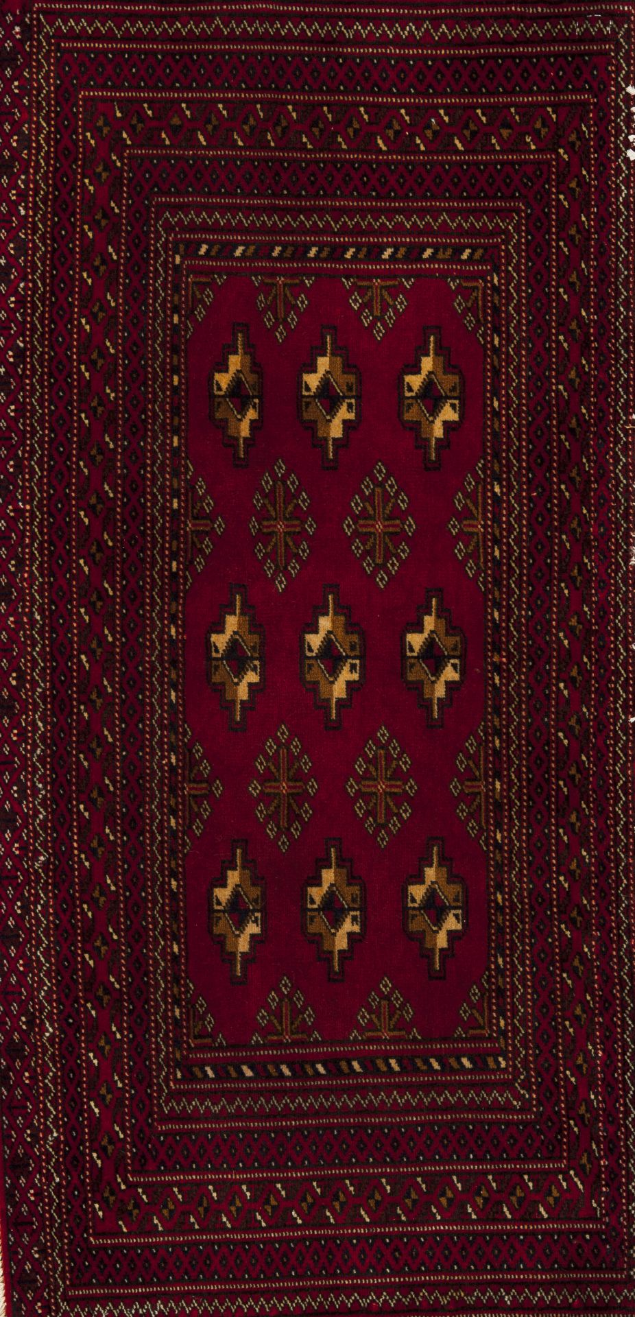 A Turkmen rug, IranWool and cotton Geometric pattern in bordeaux, beige and blue shades108x51 cm