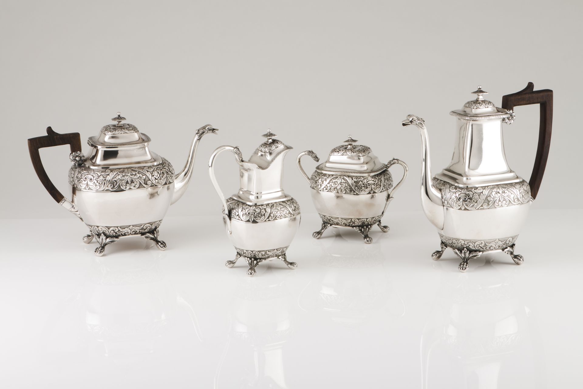 A tea and coffee setPortuguese silver Low relief foliage band decoration, swan neck spouts with