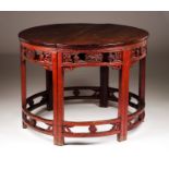 A pair of pier tablesRed lacquered wood Carved apron and stretchers, scalloped and pierced with