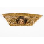 An altar fragmentCarved, gilt and polychrome wood Angel's head and foliage scroll decoration 18th