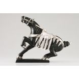 A horseHardstone sculpture with applied moulded and hammered silver elements on a stand in the
