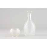 A bottle and beakerMoulded crystal Height: 24 cm (bottle) Height: 8 cm (bowl)