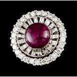 A ringPlatinum and white gold Circular shaped set with one cabochon ruby (diam.:10,8mm) 26 brilliant