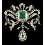 A large bow brooch with dropsSilver and gold, 19th century Set with one emerald cut emerald (ca.