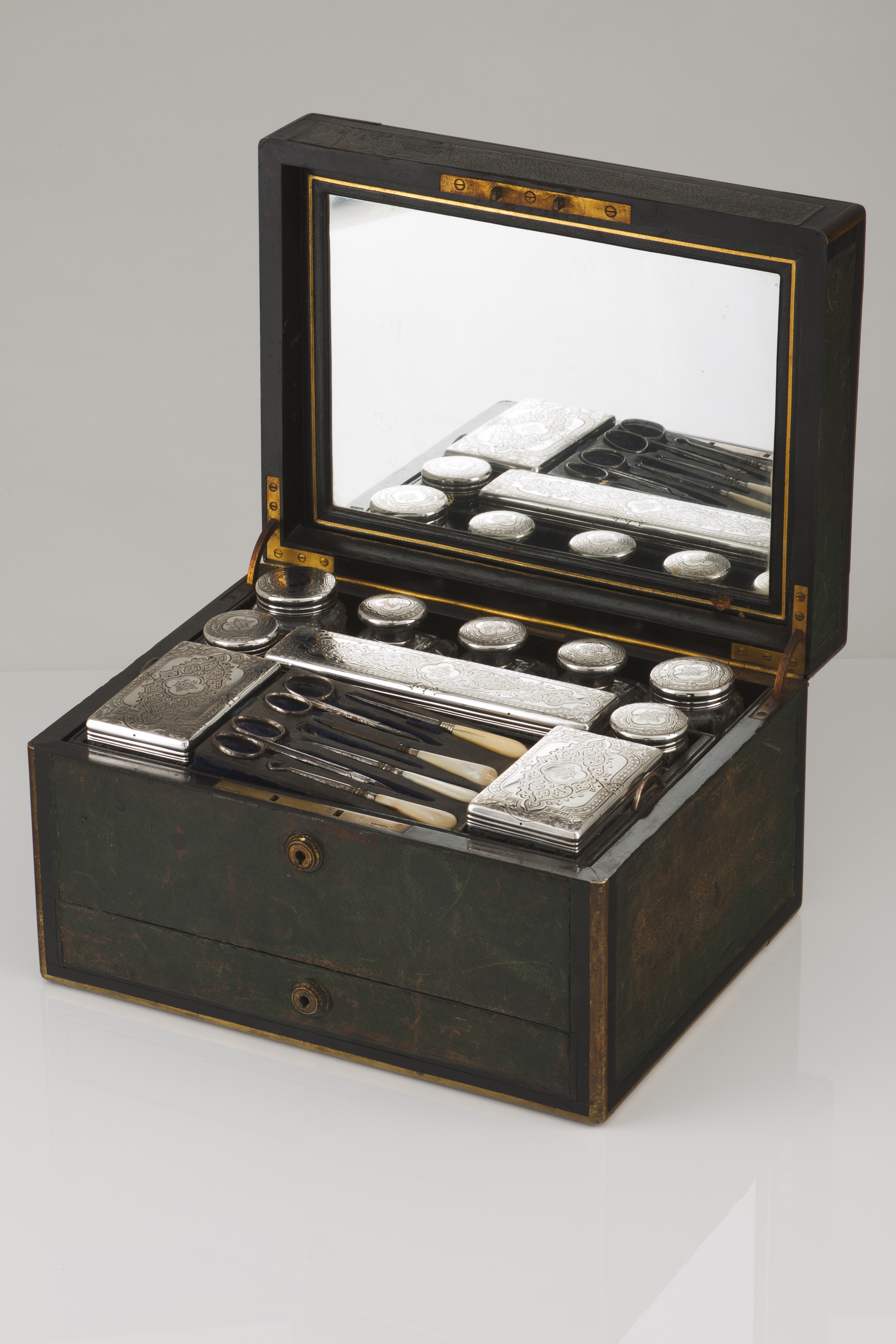 A dressing caseShagreen with various cut crystal boxes with silver covers and various other silver